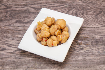 Pickled champignons in the bowl