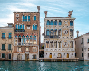 Fototapeta na wymiar 11/20/2017- Venice, Italy. The facades of Palazzo Dario and Palazzo Barbaro Wolkoff on the bank of Grand Canal
