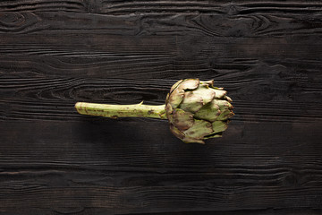 fresh artichoke on wooden table
