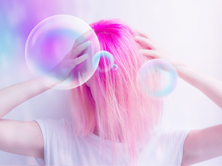futuristic looking girl with pink hair making a confused posture and bubbles