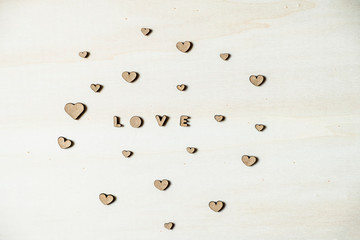 Hearts and wooden letters with love message. Flat lay wooden background