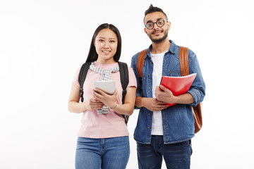 Girl and her boyfriend pose at the camera together at the university.