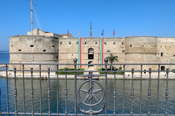 View of the Aragonese Castle with Italian flags to celebrate April 25, Italy's Liberation Day -...