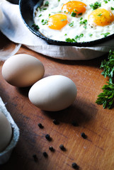 Breakfast with fried eggs, chicken eggs on the table.