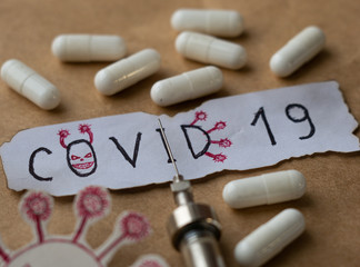 Paper with the Handwritten text COVID-19, Tablets, covid 19 syringe vaccination, coronavirus epidemic, COVID-19, 2019-nCoV