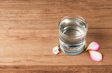 Water glass on wooden table. Glass and clean drinking water with copy space.
