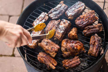 Detail of  BBQ pork ribs grilling on home smokehouse
