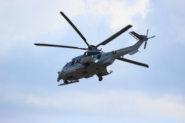 Naklejka na ściany i meble Military helicopter during the flight