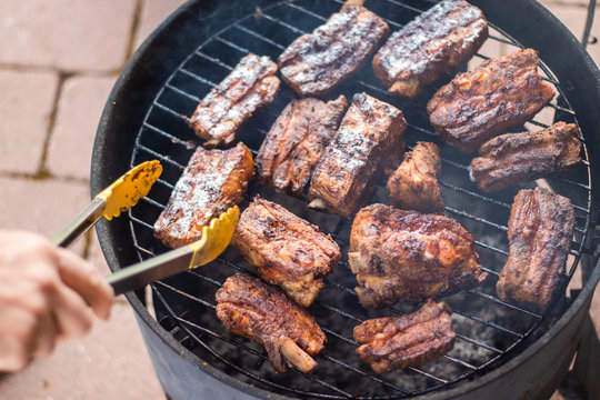 Detail Of  BBQ Pork Ribs Grilling On Home Smokehouse