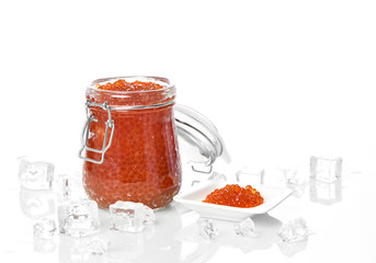Salmon or Keta fish red caviar in jar can and little plate with ice on table. Sea food. Healthy eating 