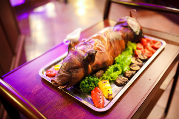 young roasted piggy pig being served at the celebration.
