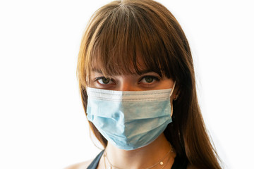 Close up face of young woman wearing disposable medical face mask with white background