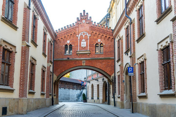 View of empty street without people of old city in Krakow, Pijarska at dawn. A cobblestone road, old red-brick houses with lights. Light backdrop. Empty background scene. Alley Of Czartoryski Princes