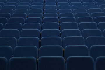 Naklejka premium Blue empty seats in the hall are prepared for participants of mass events. Organization and holding of mass events, conferences or presentations