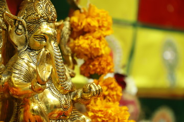 Hindu lord golden Ganesha close up 