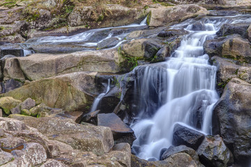 Waterfall cascading like a veil over rocky landscape