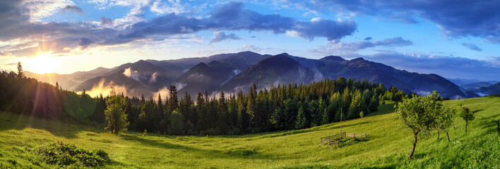 Sunrise over Carpathian mountains panoramic landscape. Alpine nature background