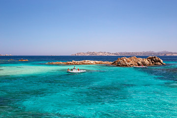 Panoramic view of the pink granite rock formations and the clear and transparent waters in the...
