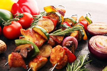 Grilled pork shish or kebab on skewers with vegetables . Food background shashlik