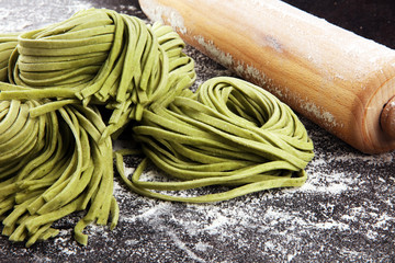 Closeup of raw homemade pasta tagliatelle. fresh italian traditional raw fresh green organic pasta