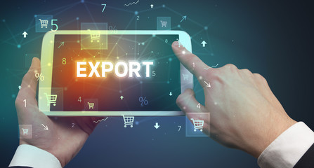 Close-up of a hand holding tablet with EXPORT inscription, online shopping concept