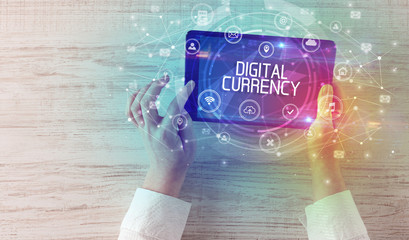Close-up of a tablet with DIGITAL CURRENCY inscription, innovative technology concept