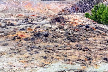 Landscape like a planet Mars surface. Solidified red-brown black Earth surface. Cracked and scorched land. Refractory clay quarries. Natural background.