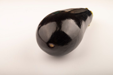 Large ripe eggplant on a white background. Close up.