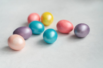 Pearl Easter eggs in pastel colors on a white table