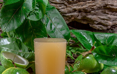 Cocktail and passion fruit juice (Passiflora edulis Sims) and fresh green fruits on a woody...