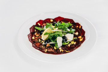 Gourmet beetroot carpaccio with cheese and herbs