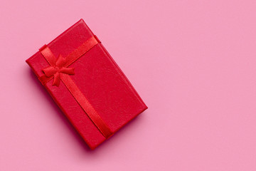 Red gift on pink background