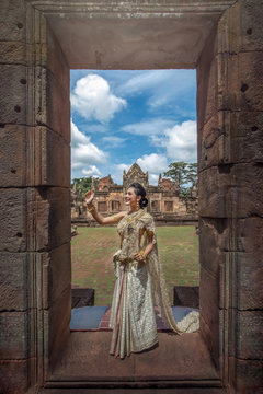 Woman wearing Thai national culture dress at the stone castle.