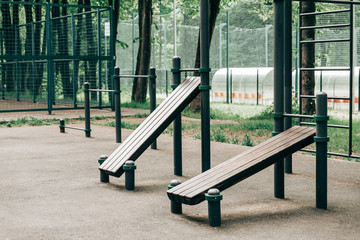 An empty training ground (workout) on the street, horizontal bars and benches for exercise on the press.