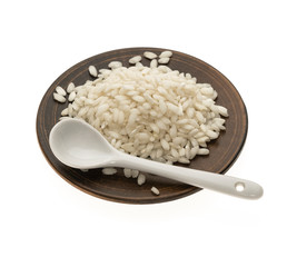 white large rice in a ceramic bowl with a white spoon on a white background