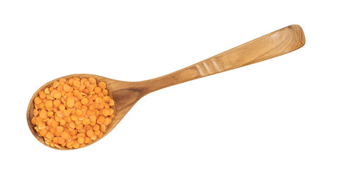 lentils on a wooden spoon isolated on white background