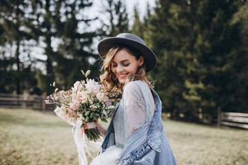 Portrait of the bride. Country style. A young girl in a blue gray wedding dress, denim jacket and...