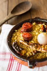 Migas with onion, chorizo and dried peppers. A traditional dish in the spanish cuisine made with breadcrumbs