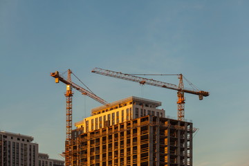 construction site with cranes against the blue sky	