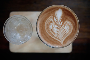 Cup of coffee with beautiful Latte art. Top view. Close up.