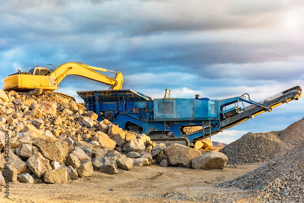 Wall mural Stone crushing machine in a quarry or outdoor mine