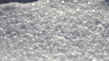 Fluffy sparkling snow. Snowflakes sparkling in the sun. Snow in the winter. Snow carpet. Snow background
