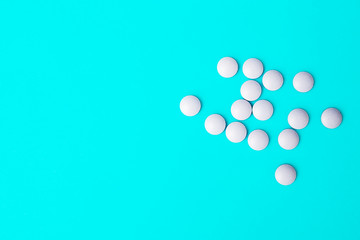 Blue pills on a blue background. Space for text. Concept for medical news.