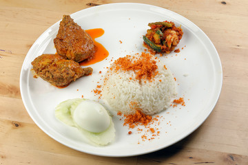 Nasi Lemak Rice cooked with coconut milk floss with curry chicken sambal vegetable boiled egg cucumber slice