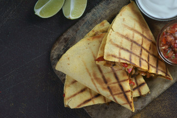 quesadilla with salsa on a wooden background