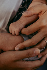 Mother holds her baby finger 