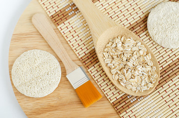 Spoon with oatmeal, cosmetic brush and loofah sponge. Natural beauty treatment and zero waste...