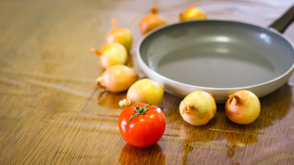 Cooking. Onions And Tomatoes Dance Around The Frying Pan.