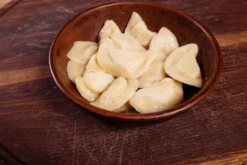 vareniki with cheese are Ukrainian foods on a wood background