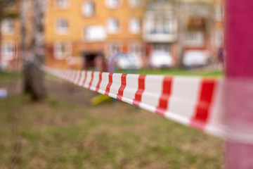 A white and red ribbon prohibits entry to the Playground. Playground swing in the open air...